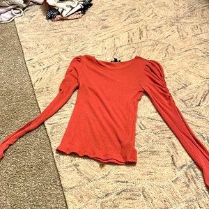 Pink long sleeve top with ruffles on top of sleeves